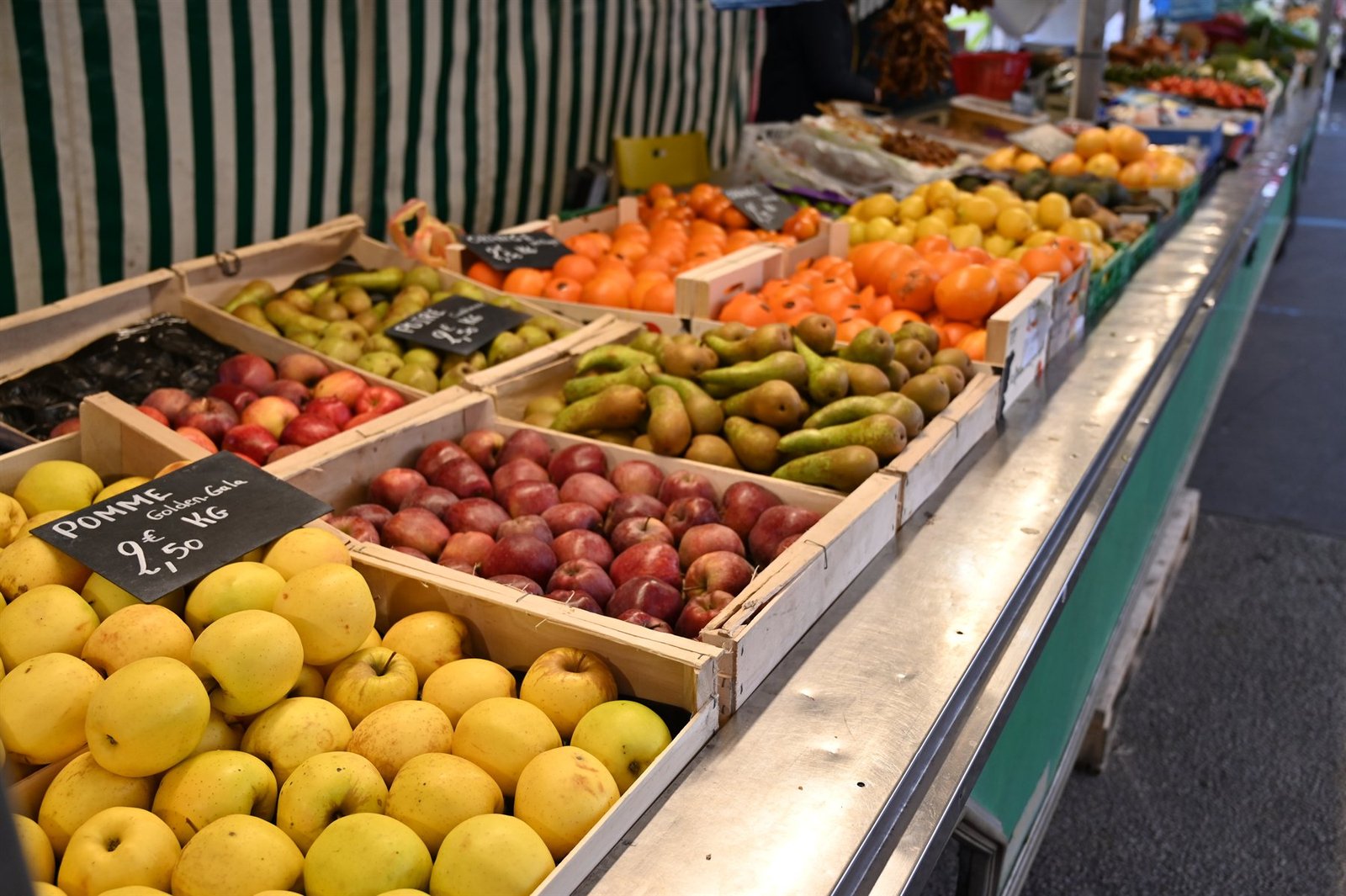 Étal de pommes, poires et agrumes avec ardoises de prix